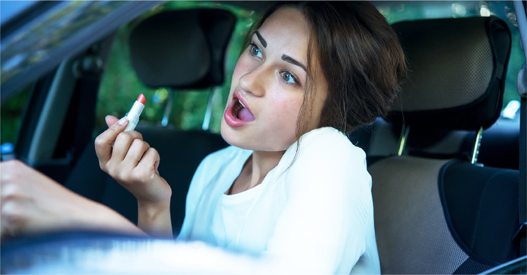 صورة فتاة جامعية تلاحظ إمكانية رؤية السيارات خلفها باستخدام مرآة الميك آب